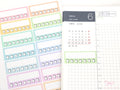 Colorful planner stickers with a calendar sheet on a white background
